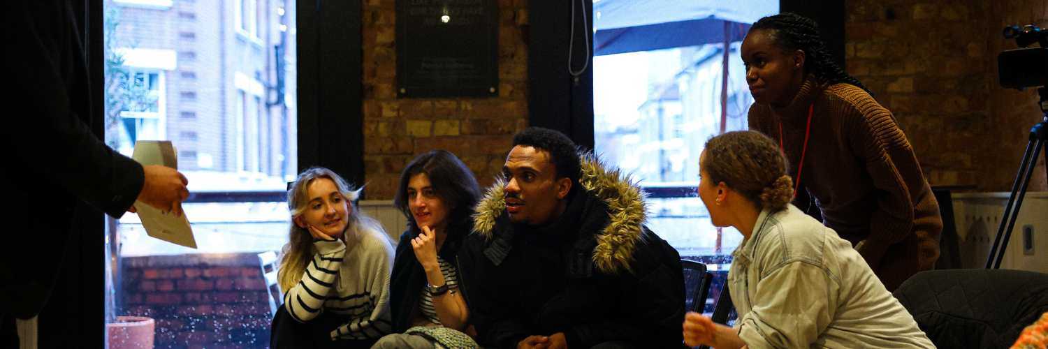 A group of people sat on chairs in a workshop