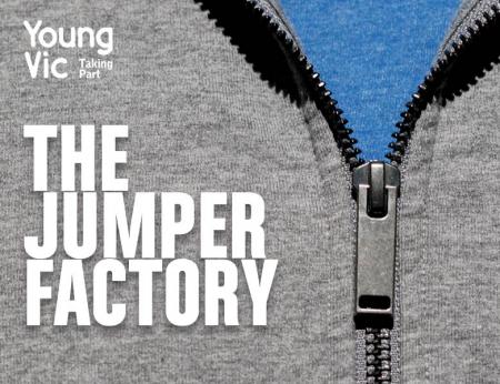 A zoomed in image of a grey hooded sweatshirt, focussing on the zip detail. We can see the blue t-shirt beneath. The words THE JUMPER FACTORY hover in white in front of the image, along with 'Young Vic Taking Part in the top left hand corner