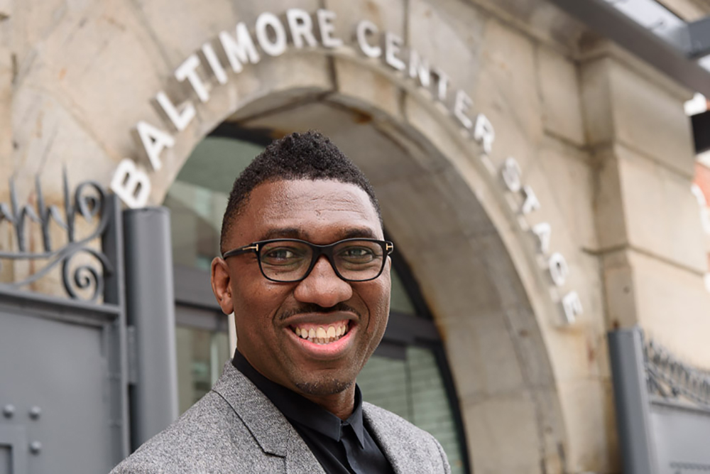 A photo of Kwame Kwei-Armah taken outside the entrance to Baltimore Centre Stage