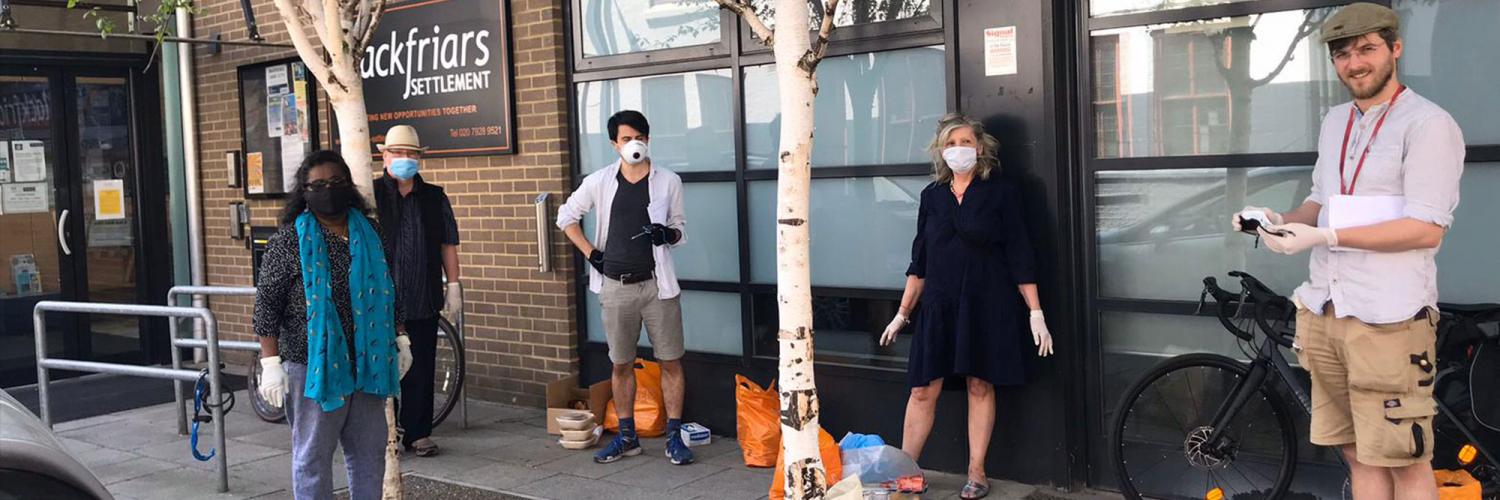 A group of volunteers stand outside Blackfriars Settlement office