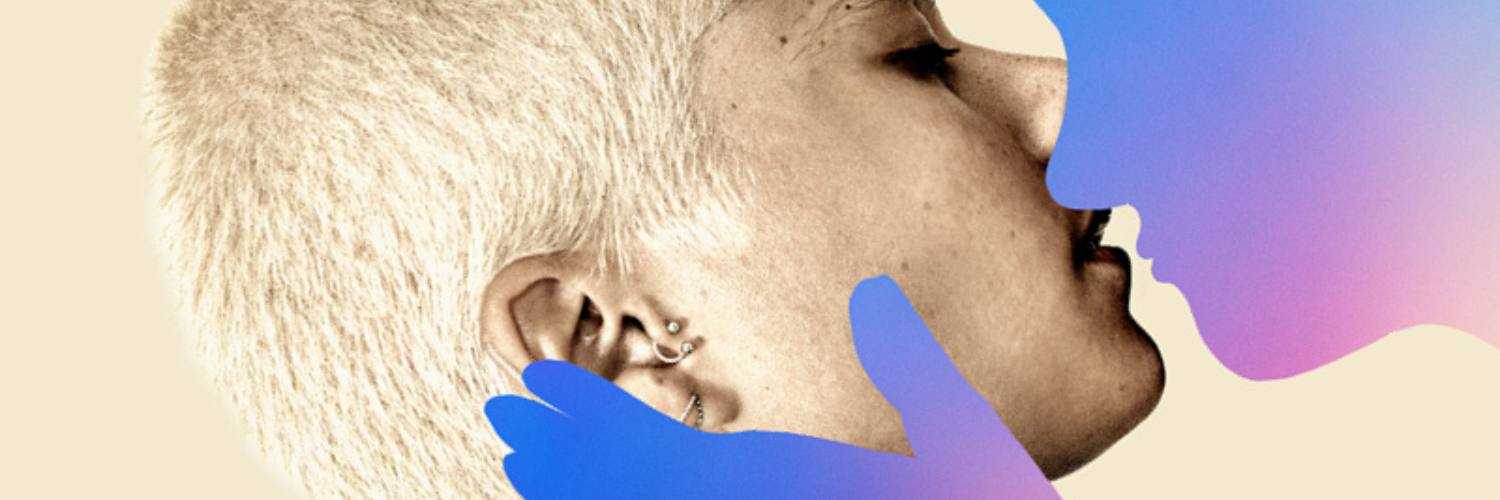 The side profile of a person with short cropped hair and multiple earrings in their ear. They are leaning up to almost kiss a blue and purple silhouette of a person. The silhouette person has a hand extended to cup the side of the other person's face. 