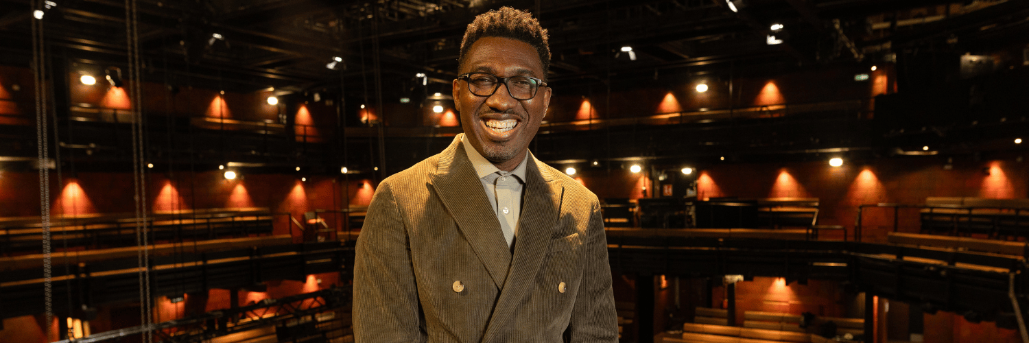 Kwame Kwei-Armah in a green double  breasted, corduroy suit.