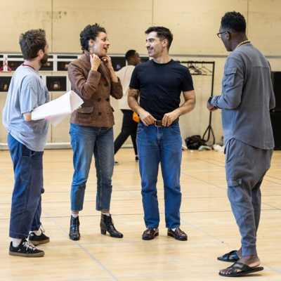 Cast members Olly Dobson, Anoushka Lucas and Stavros Demetraki stand in a circle with show director Kwame Kwei-Armah.