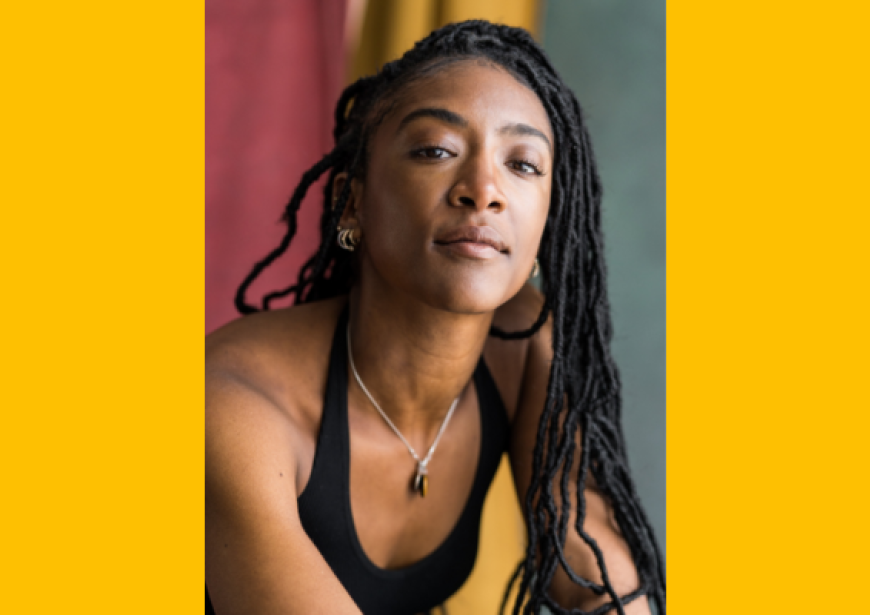 A headshot of a tall Black woman with braids