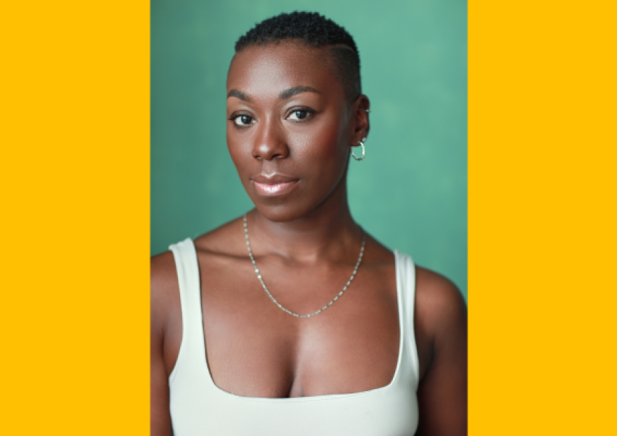 A headshot of a person with short cropped hair in a cream singlet 