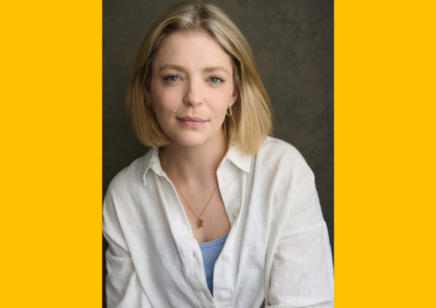 A white woman with shoulder length blonde hair wearing a white long sleeve blouse