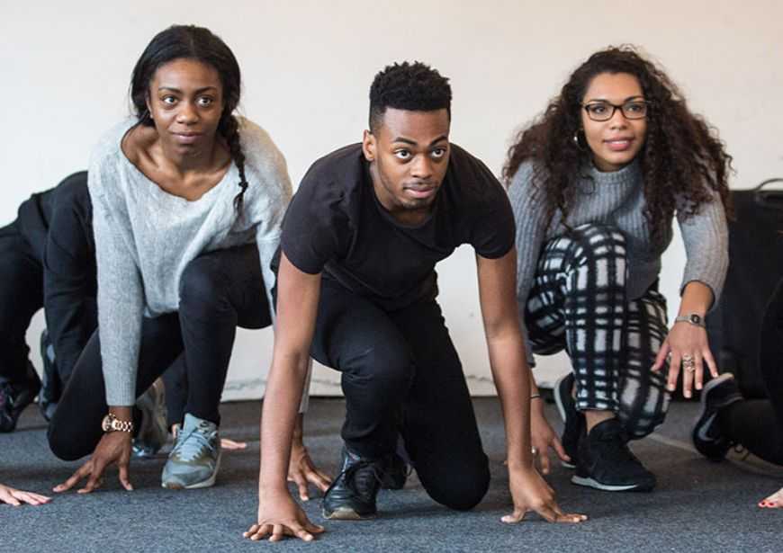 Directors in workshop, crouched like they are about to start a race.