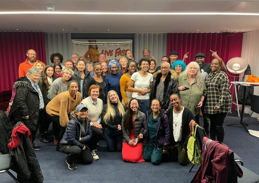 A photo of around 30 people smiling at the camera.