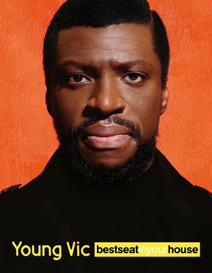 Best Seat in Your House: Mandela. From 19 - 23 Jan 2023. Image description: A man, wearing a dark coat, staring intently at the camera against an orange background. At the bottom of the image are the words, 'Young Vic Best Seat in Your House', in black white and yellow 