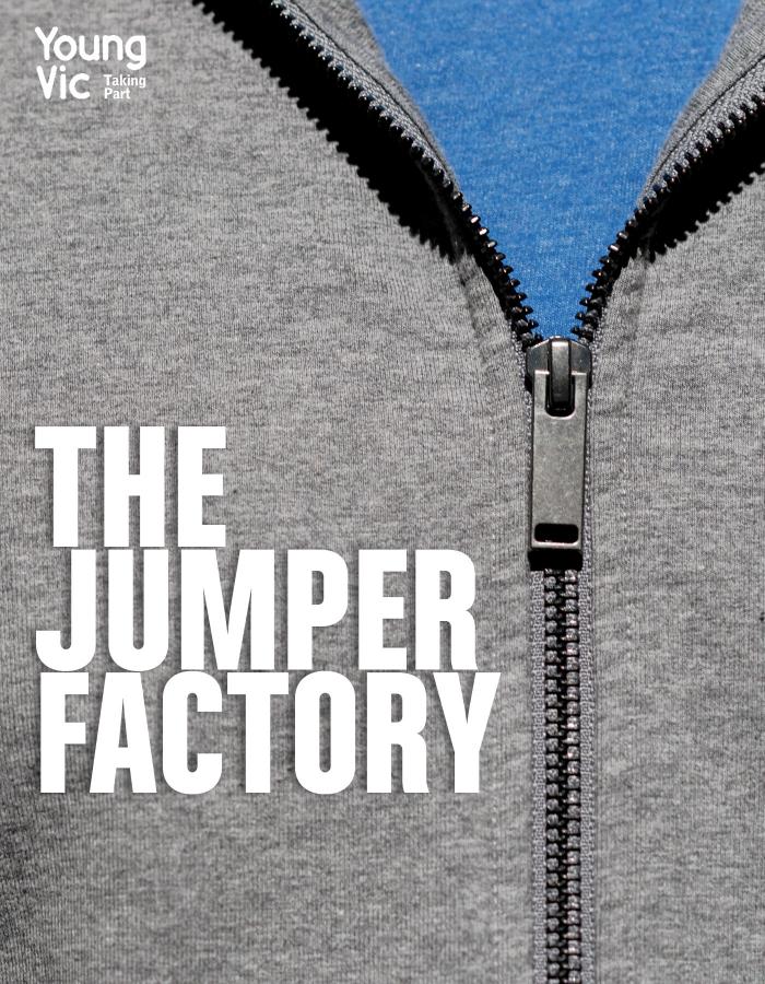 A zoomed in image of a grey hooded sweatshirt, focussing on the zip detail. We can see the blue t-shirt beneath. The words THE JUMPER FACTORY hover in white in front of the image, along with 'Young Vic Taking Part in the top left hand corner