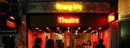 Entrance of theatre, Young Vic in yellow neon lettering and theatre in red neon lettering.